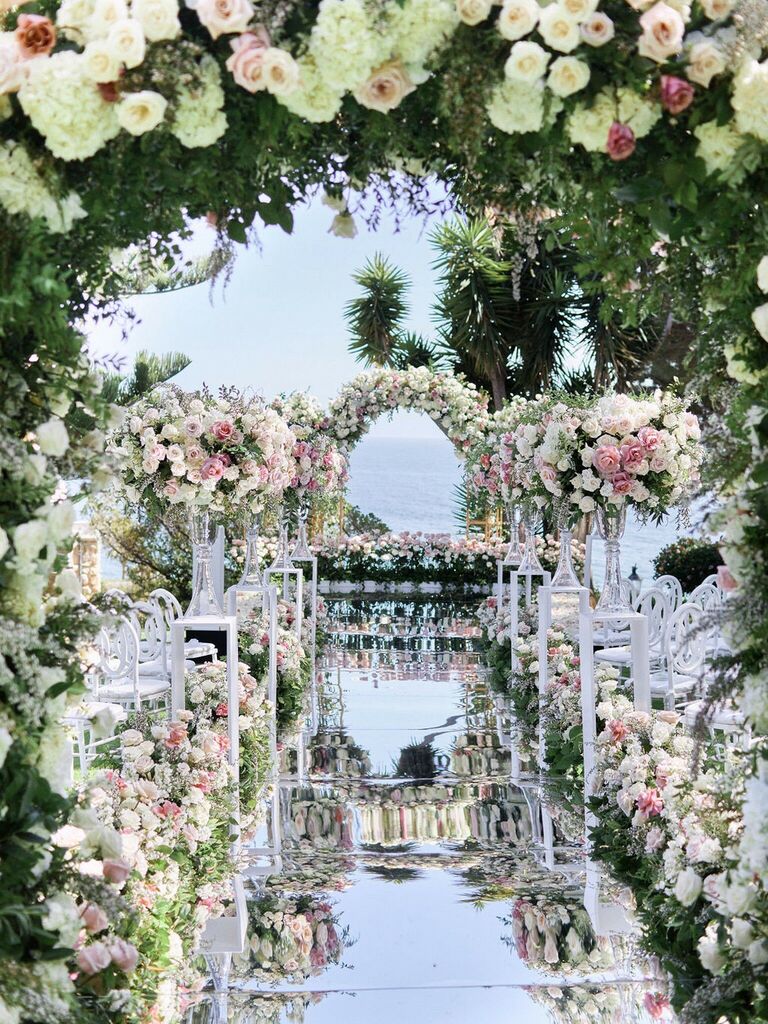 Mirrored aisle runner lined with colorful roses. 