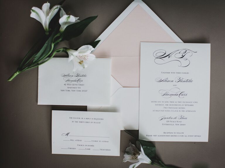 elegant spring wedding invitation with black calligraphy against white background and blush pink envelope liner