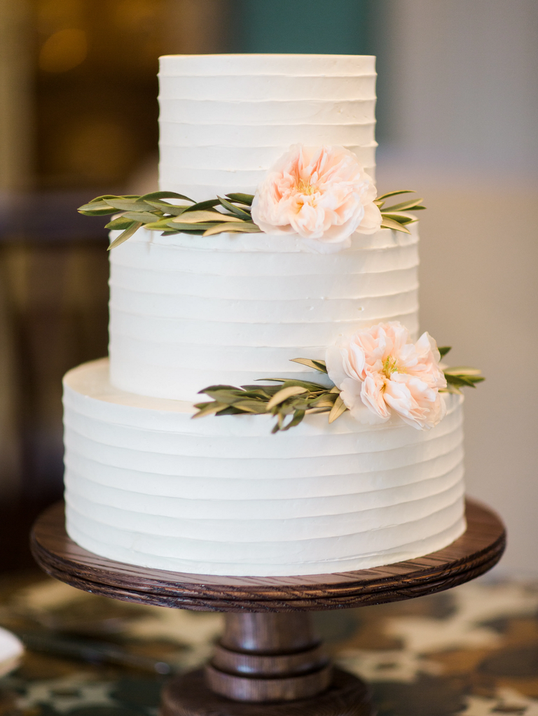 three tier white buttercream wedding cake with flowers