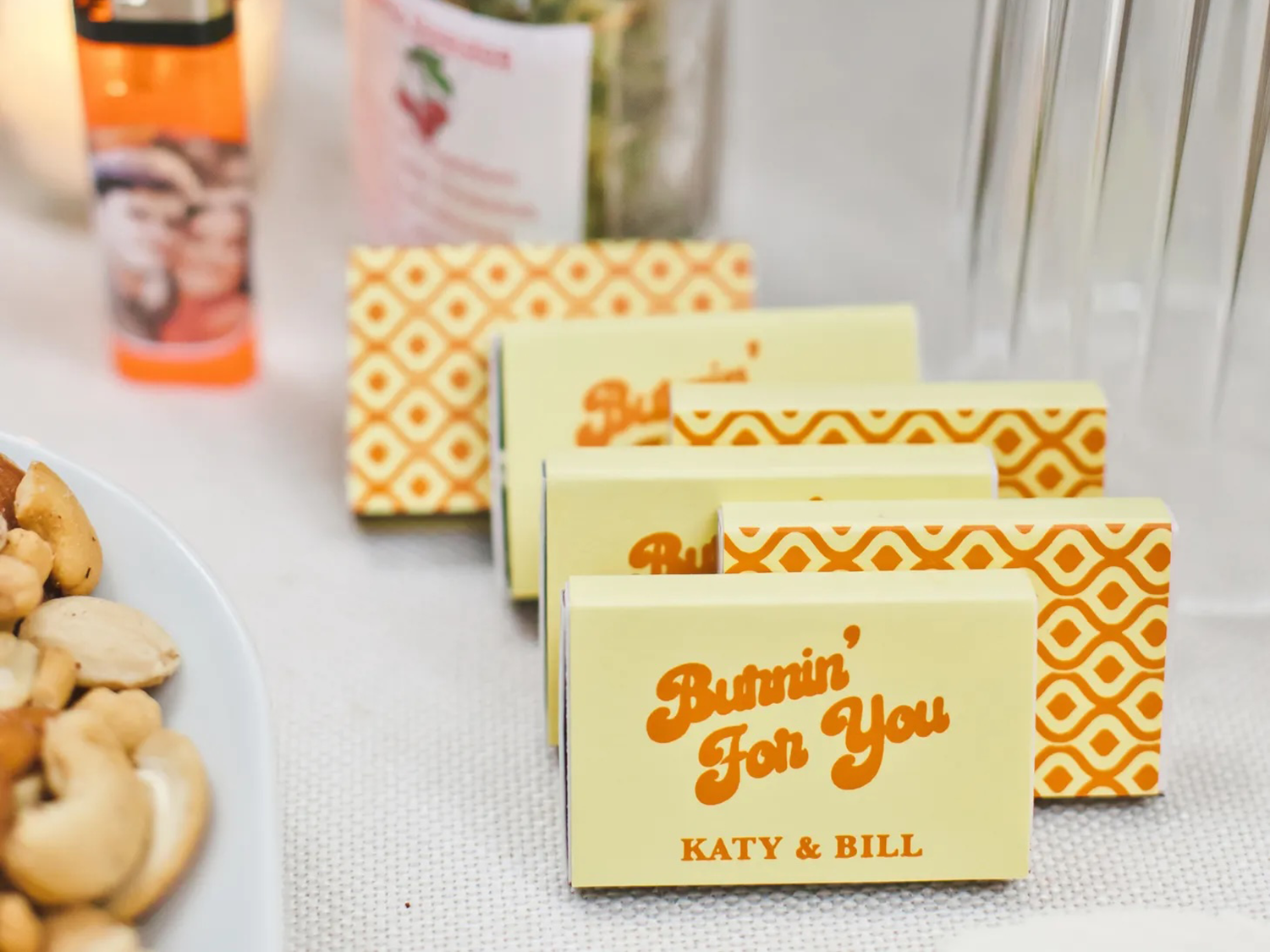 Custom photo matchboxes for wedding in yellow and orange that say "Burnin' for you"