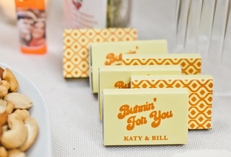 Custom photo matchboxes for wedding in yellow and orange that say "Burnin' for you"