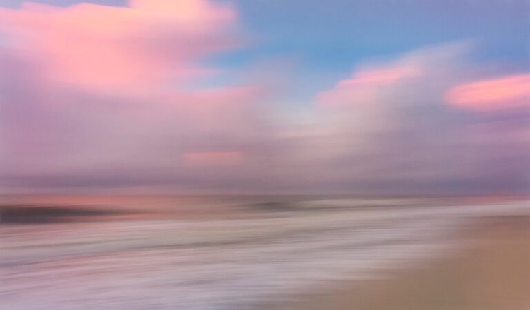 myrtle beach sunrise pink clouds and sand and blue skies and artistic interpretation of the atlantic ocean