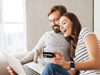 couple looking on computer and holding credit card