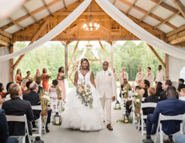 Couple walking down the aisle at The Cabin at Old Spur wedding venue in Timmonsville, South Carolina