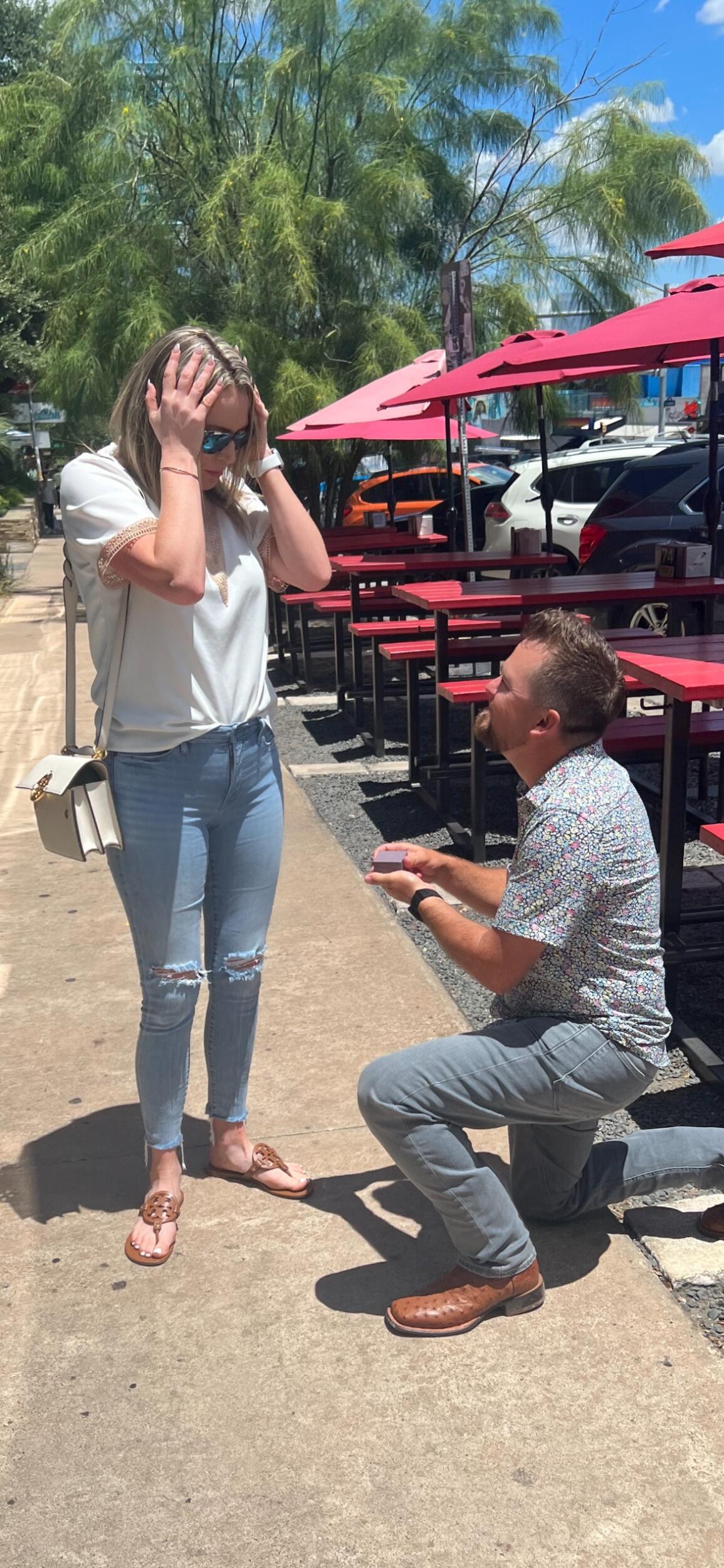 We are on the way to Dallas TX to meet with Aimee’s parents and go see our favorite country singer Garth Brooks. Michael got nostalgic and wanted to stop in Austin for lunch and Google Maps lead the way (Ha-ha). After a juicy burger at the same Hopdoddy where we had our first date, Michael pointed out the table we sat at so long ago and suggested a photo. We asked a stranger walking down the street to snap a quick photo of us. First photo was taken, Aimee went for the phone and Michael asked for the woman to take one more. Aimee stood back for another photo and Michael was down on one knee. Aimee’s eyes filled up with tears and Michael asked “Will you marry me?” In a state of shock and excitement Aimee’s response was “WHAT?!?!?”. Michael chuckled and ask her again and she instantly yelled “YES!!!”