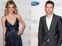 Ashley Hinshaw and Topher Grace pose at an event
