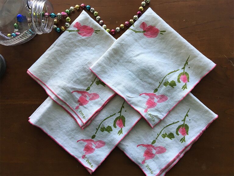 Simple pink floral and pink border on white cloth napkin