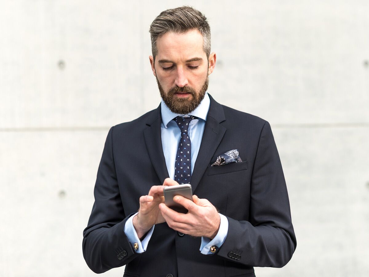 Man in a suit on his smartphone 