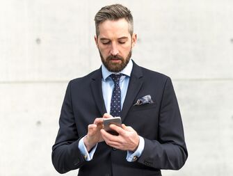 Man in a suit on his smartphone 