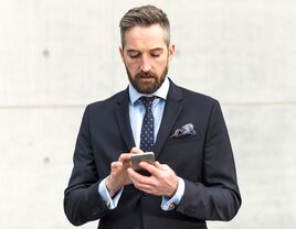 Man in a suit on his smartphone 