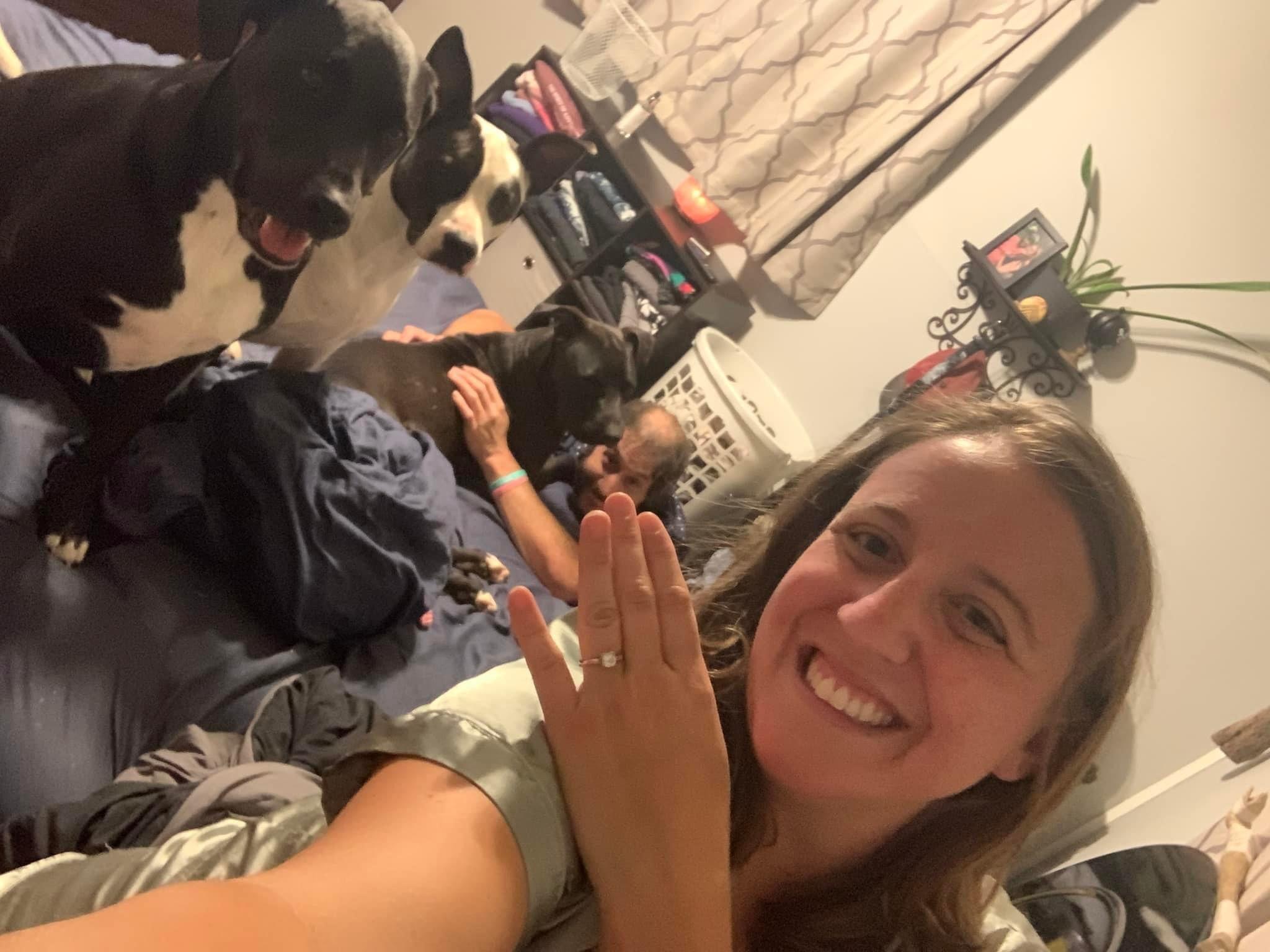 WE GOT ENGAGED: Joe proposed in absolutely the most perfect way. It was a bit of a chaotic week (adopting a new dog and dog sitting for John and Suzanne just scratched the surface). We were laying in bed together in a pile of doggy snuggles and were talking about how happy we are together. Sarah started to fall asleep cuddling the dogs, and Joe snuck away to the other room. When Joe returned, he gently woke Sarah and handed her a few items, including dog treats for the boys. Joe had to remind Sarah to look at the other item, which was a handwritten note folded up. Sarah opened it and read the sweet letter which ended with "Please join me always and forever".  After confirming that the answer was "YES", we both kissed, slow danced, and called our families to share the news. 