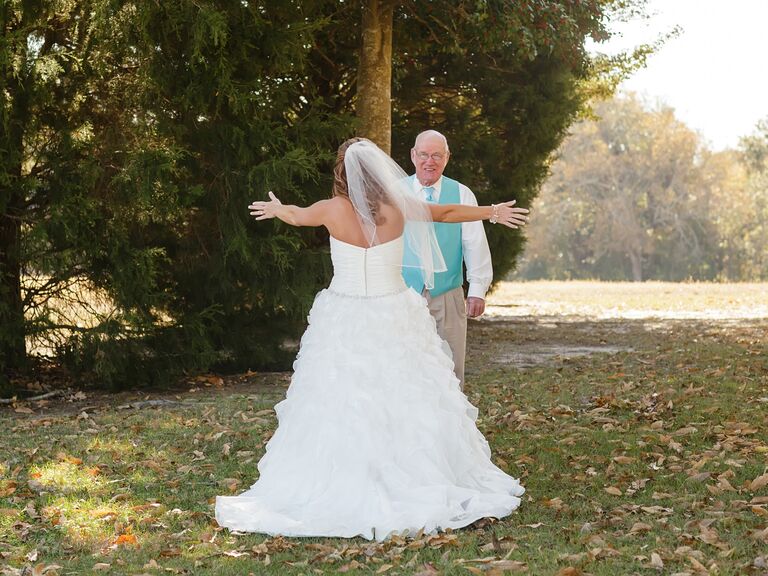 A bride hugging her father for the first time on her wedding day