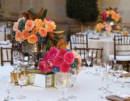 Pink and Orange Rose Centerpieces in Silver Vases on Elegant Reception Table