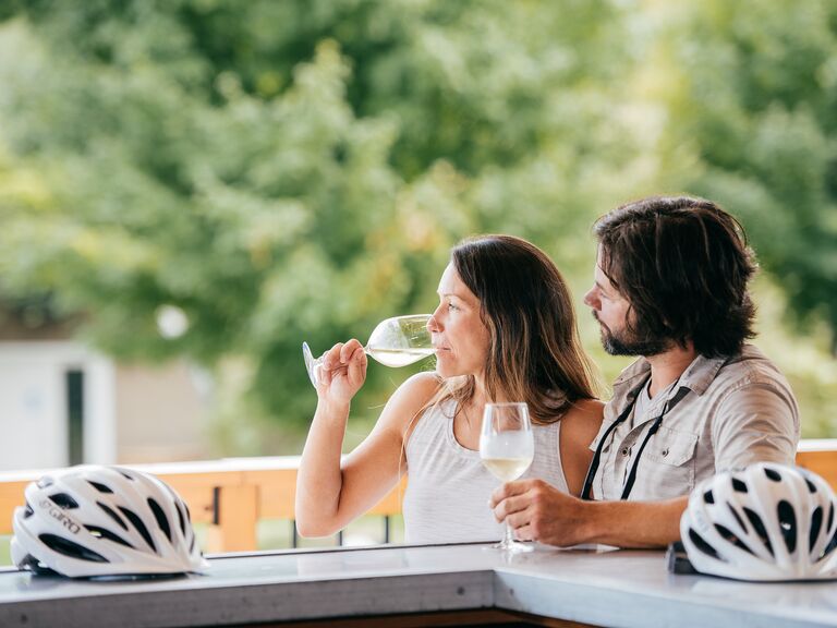 Couple drinking wine, at Inn at Black Star Farms