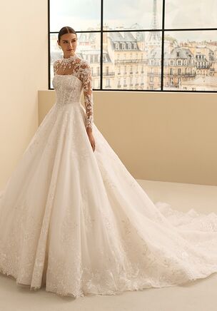 Two-piece bridal gown in beaded lace with silver thread featuring strapless neckline and princess silhouette. Includes jacket with removable straps.