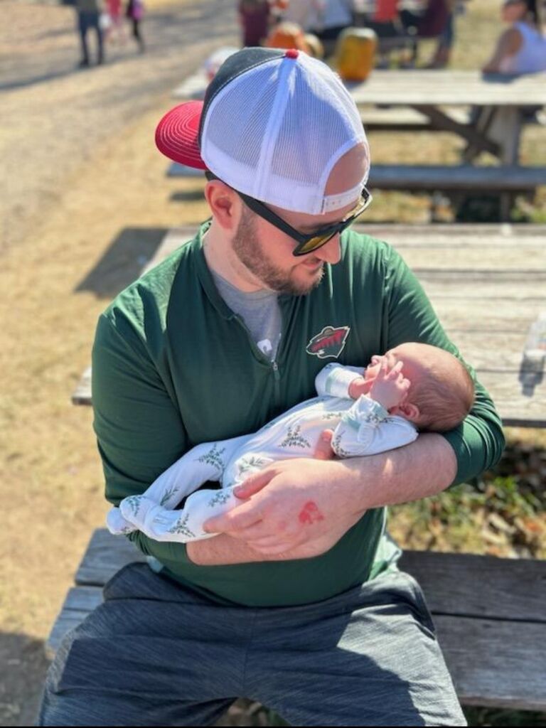 Blake holding Miki's brand new nephew, Leo for the first time.