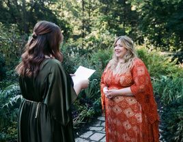 Brides exchanging wedding vows during wedding ceremony