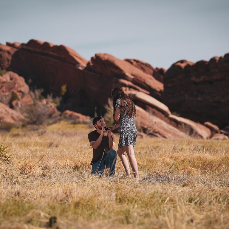 While in Colorado for clinical rotations, Dylan told Aly their friend Ben was coming up for the weekend to take some graduation photos. After the grad photos, Dylan told Aly they should take a picture with him on her back. Aly was waiting for Dylan to jump on when she turned around and saw him on one knee. 