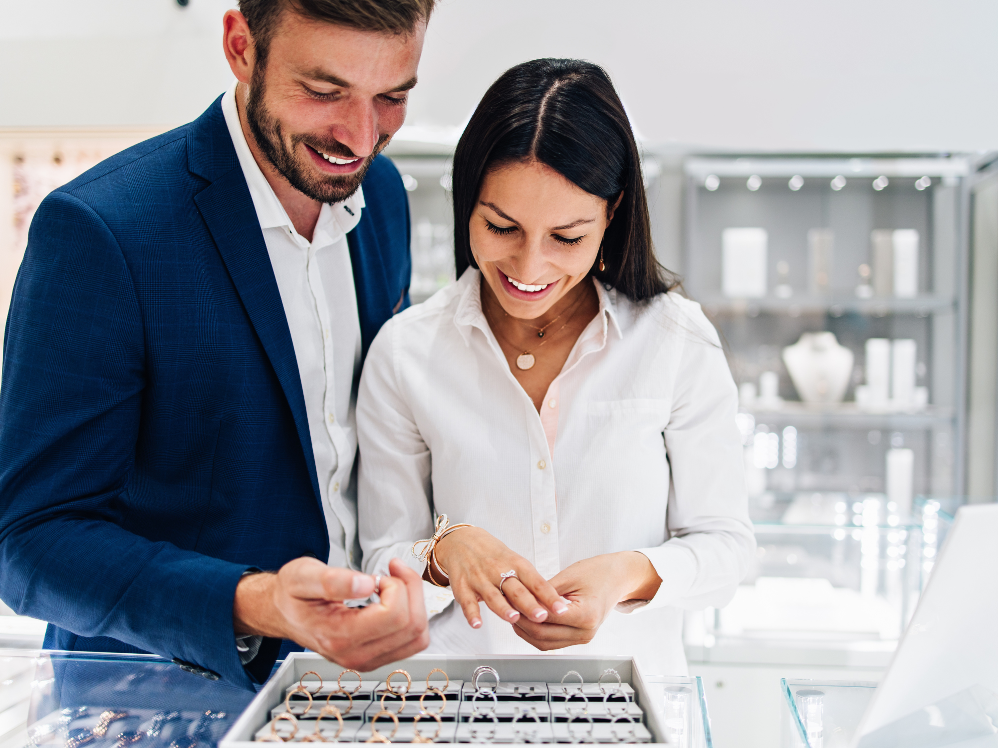 Man and woman shopping for engagement ring