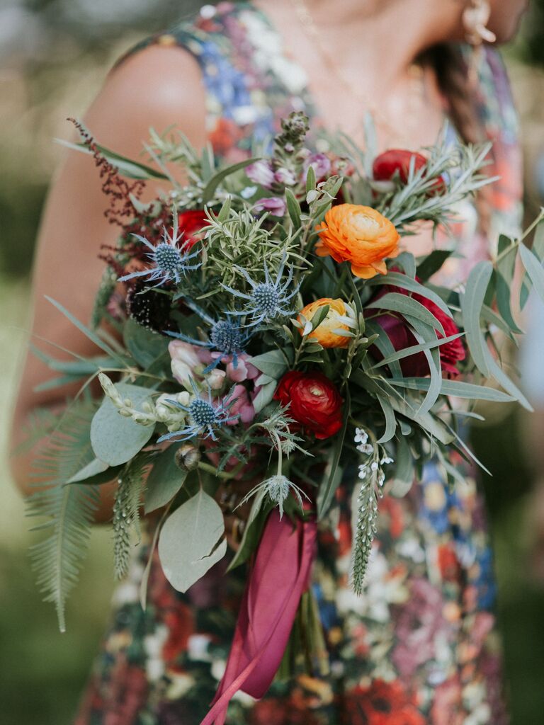 Colorful bridal bouquet with ranunculus, thistle and eucalyptus.