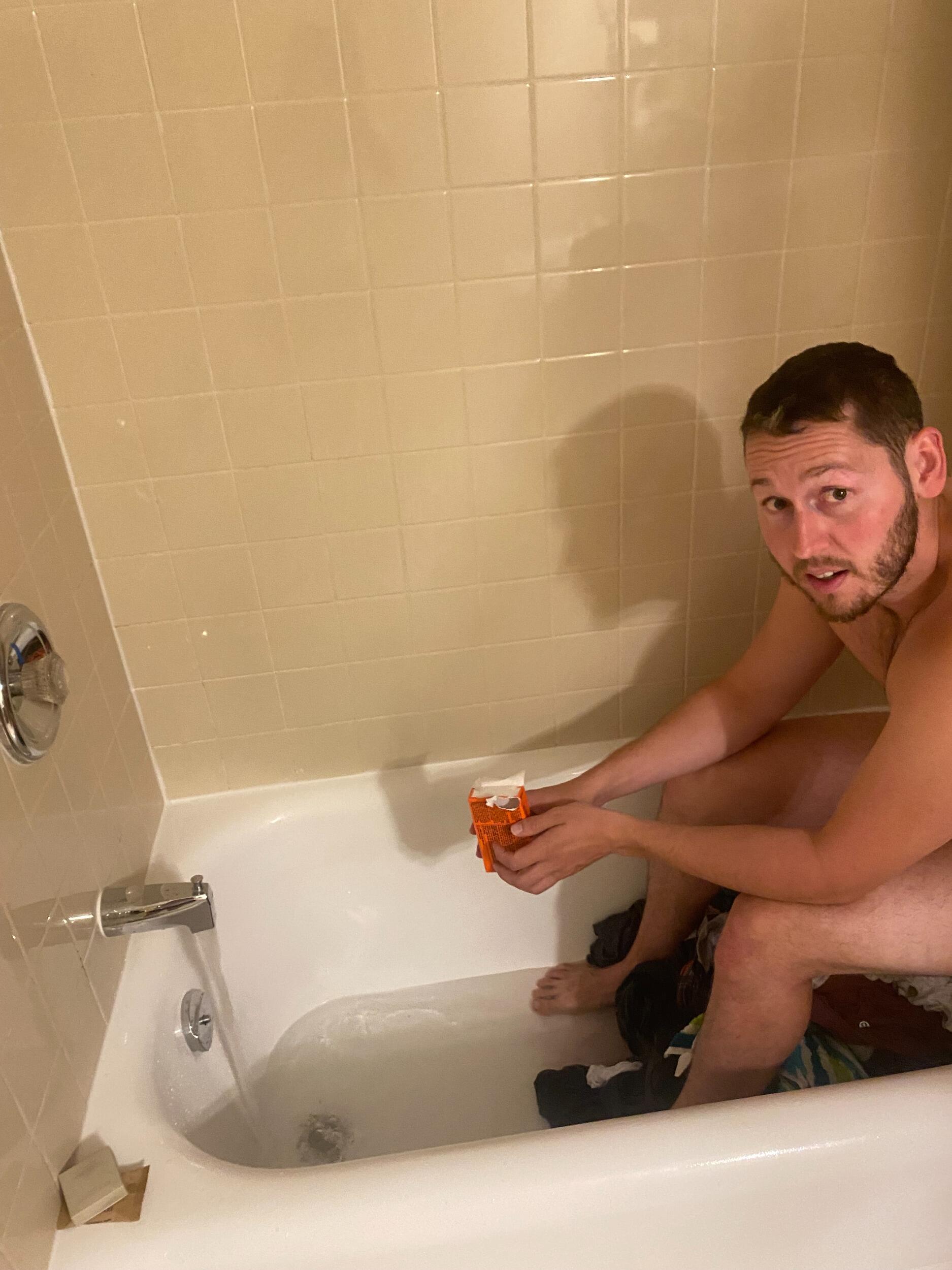 Dennis doing our FULL garbage bag of laundry in the hotel bathtub before we realized there was no where to properly hang or dry our clothing...
