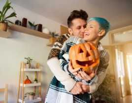 Cheerful couple with Jack O' Lantern pumpkins