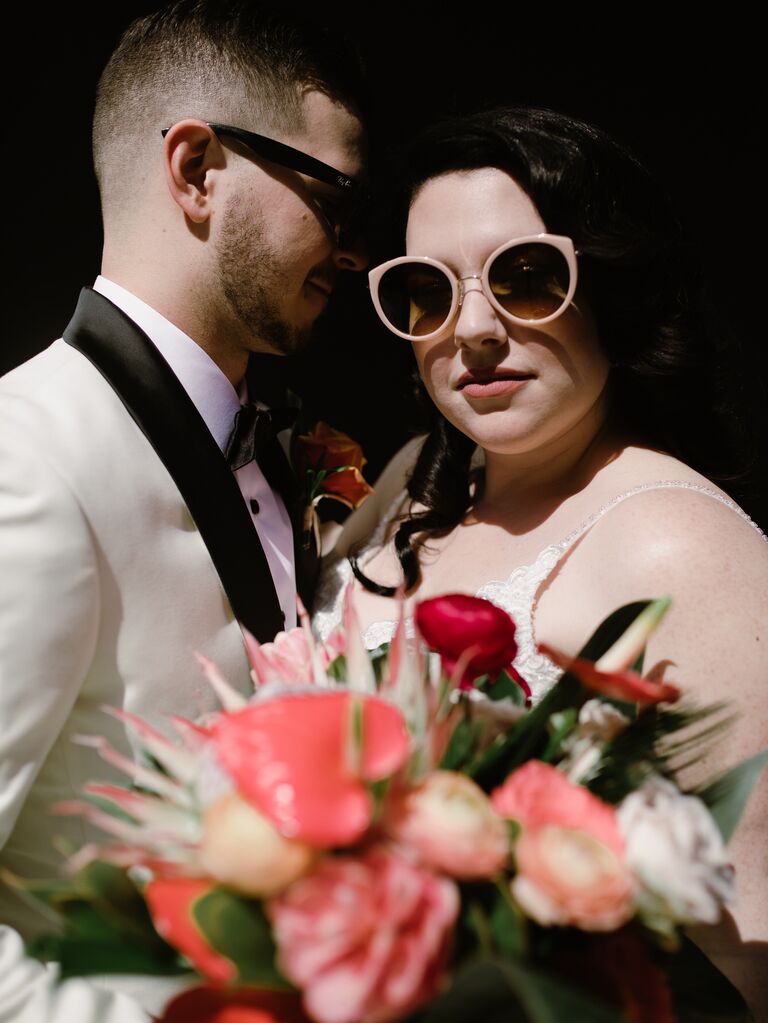 Chic and dramatic bride and groom wedding photos with floral bouquet