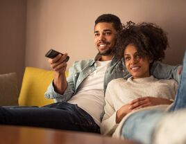 Couple at home watching TV