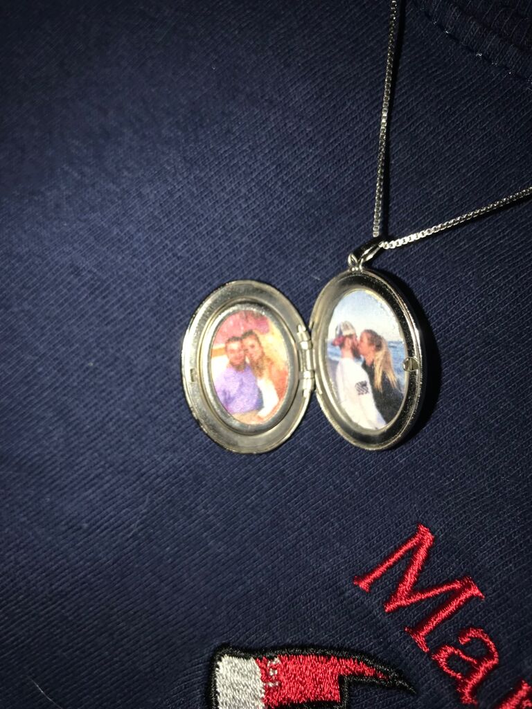 Celebrating one year together with a locket containing photos of us.