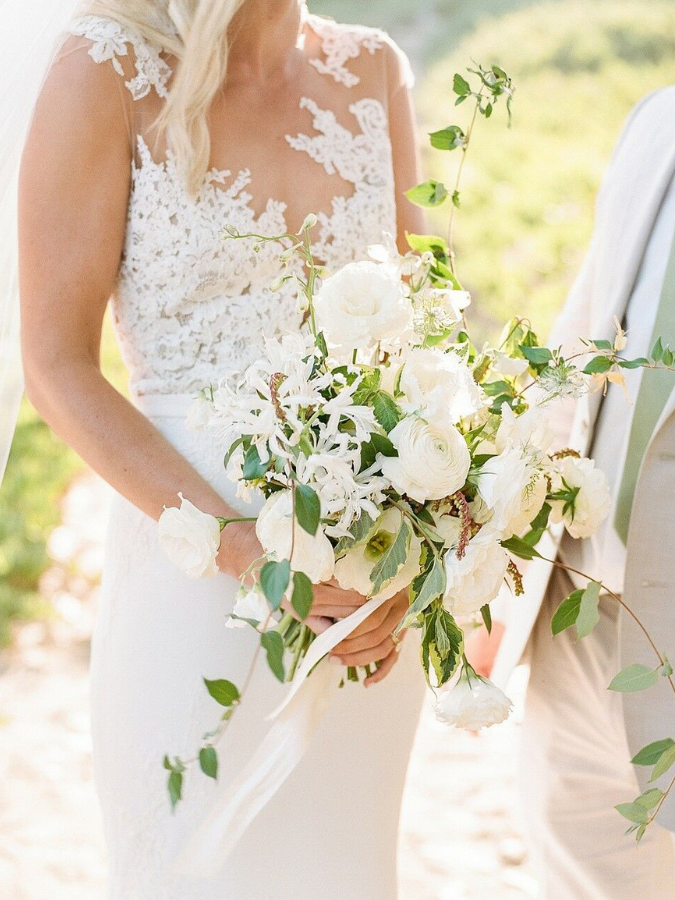 Bride holding organic white-and-green bouquet
