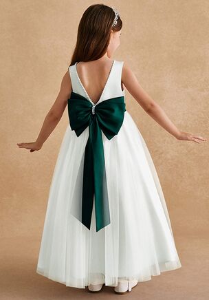 Cookie is our classic satin and tulle flower girl dress. She features a bateau neckline and a V-back adorned with beaded trim and a satin bow tie. The gathered tulle A-line skirt will make you want to twirl at your next special occasion. This dress is not only perfect for a flower girl at a wedding but also versatile enough for other special occasions.