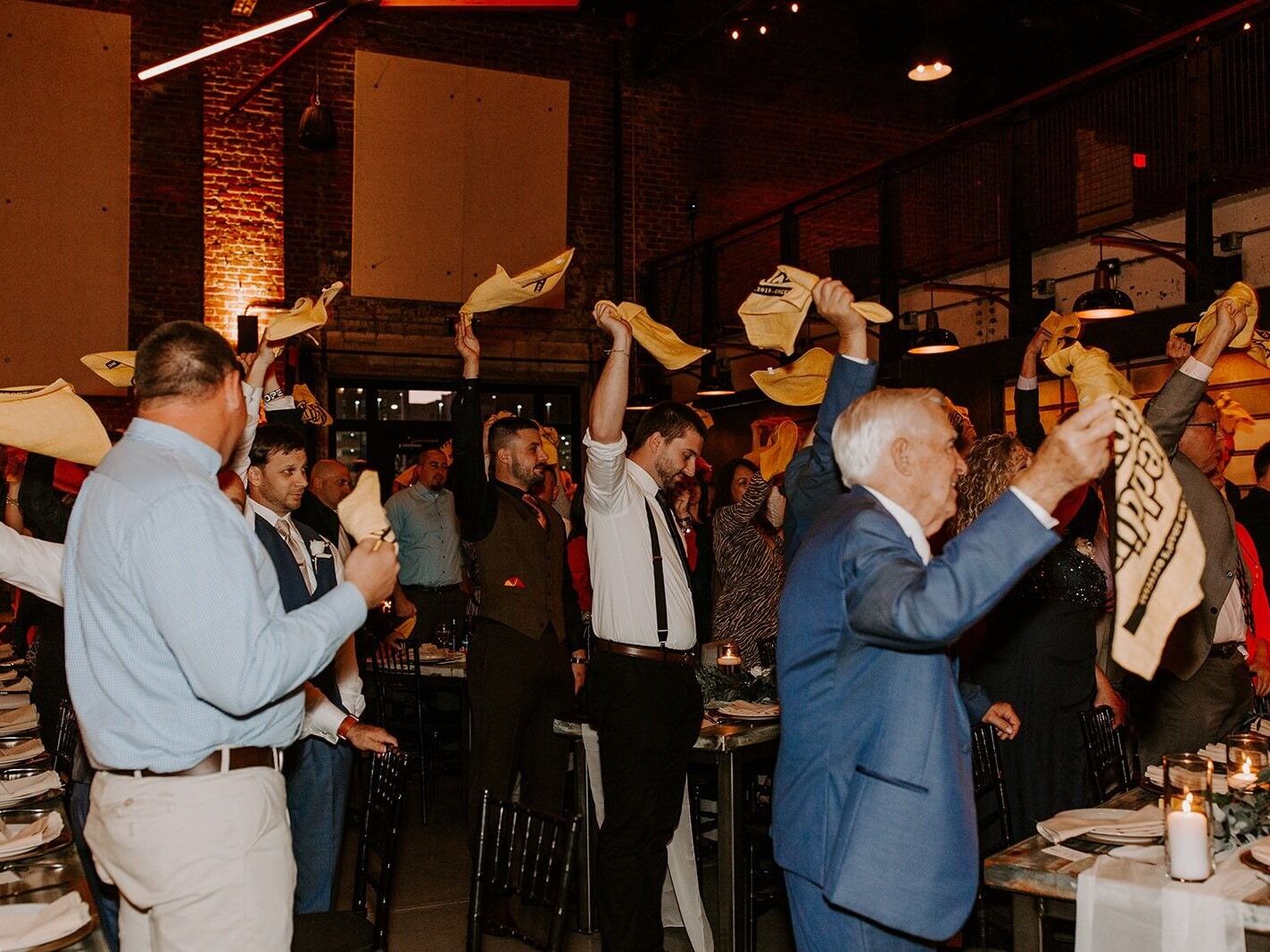 Guests dancing while spinning napkins around their heads