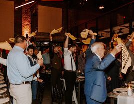 Guests dancing while spinning napkins around their heads