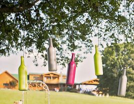 Hanging wine bottle ceremony backdrop