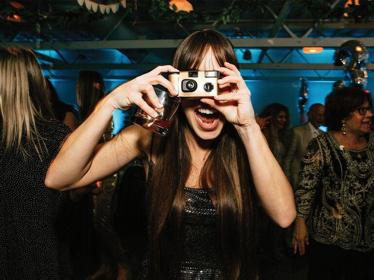 Girl taking photo with disposable camera