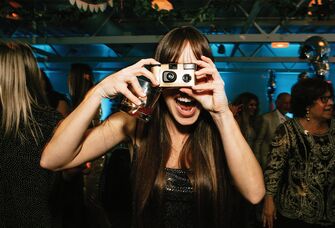Girl taking photo with disposable camera