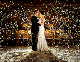 Bride and groom on the dance floor surrounded by confetti for their wedding after-party.