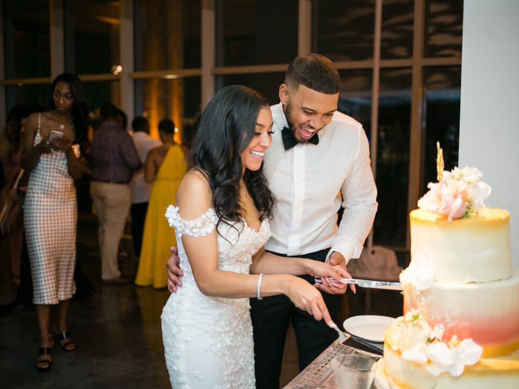Couple cutting wedding cake together