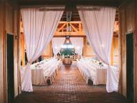 Decorated barn with curtains and tables