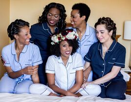 bride and bridesmaids posing in coordinating navy and light blue pajama sets