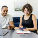 Couple looking at budget on computer