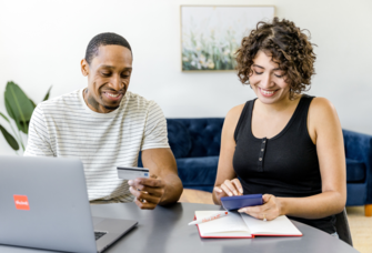 Couple looking at budget on computer