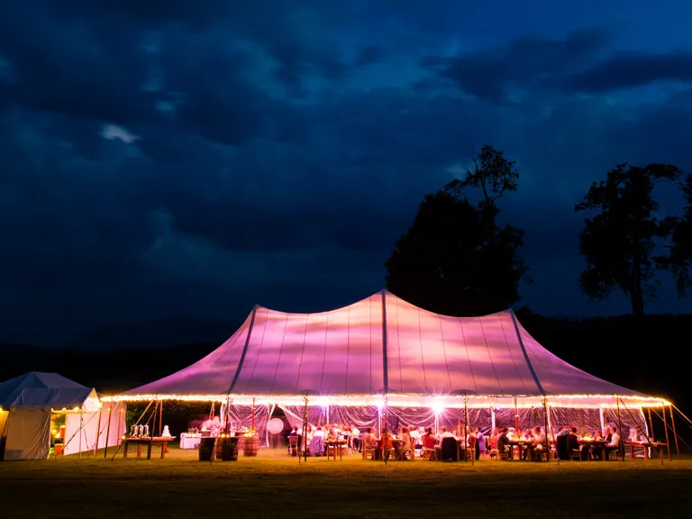 White outdoor wedding tent rental with pink lights from Go To Event Rentals in Orlando, Florida