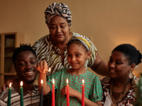 Family lighting candles for Kwanzaa celebration