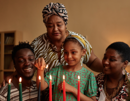 Family lighting candles for Kwanzaa celebration