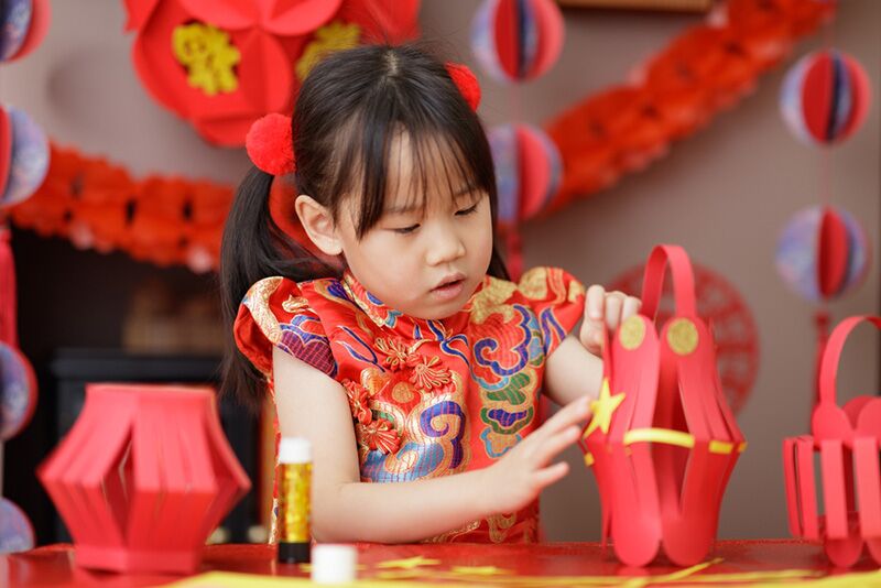 Young girl making lanterns for Lunar New Year