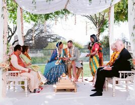 Couple and family during hindu wedding ceremony.