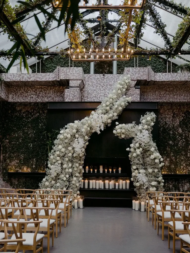Elegant Ceremony Altar With Asymmetrical White Floral Structure Backdrop, Candles, Greenery