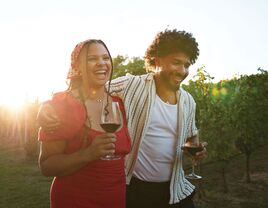 Couple in love walking through vineyard for winery proposal