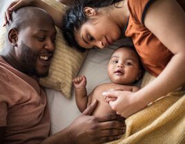 parents snuggling with baby